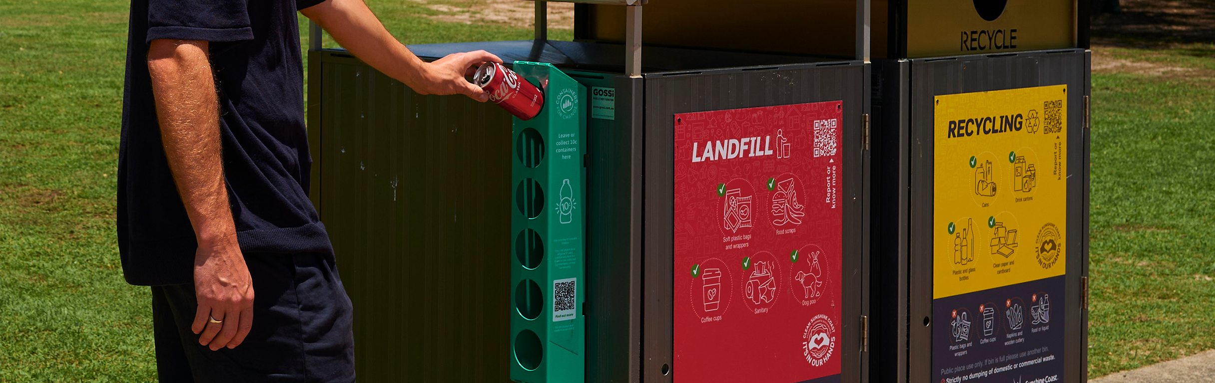 Man using Containers for Change Container Exchange Point mounted to council bins in park