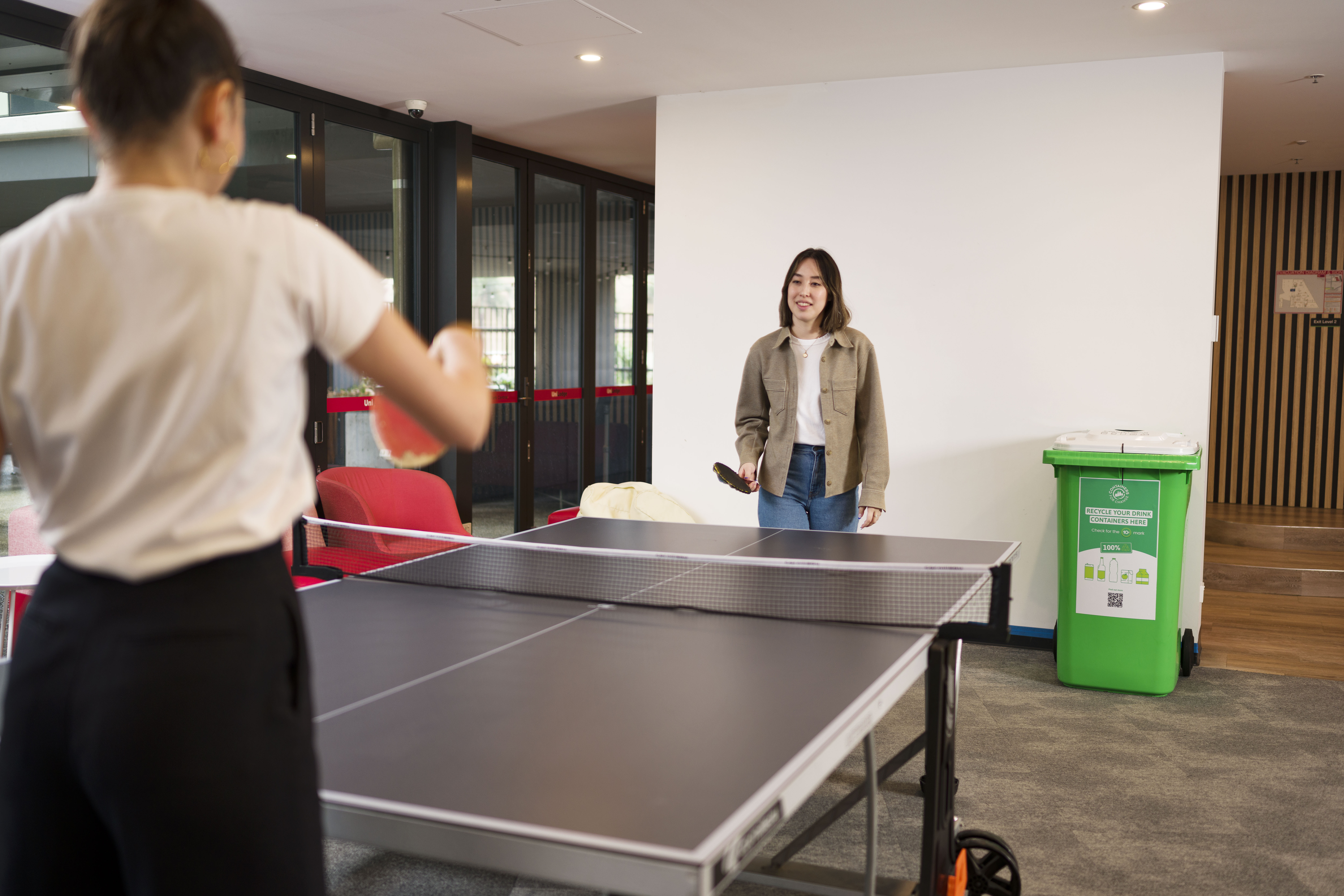 Two millennials playing table tennis