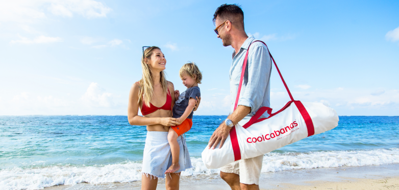 CoolCabanas couple with toddler at beach