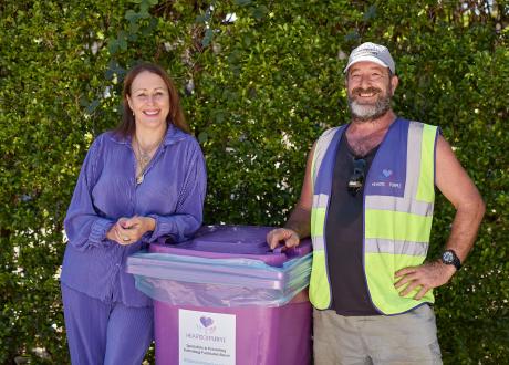Women and man leaning on purple bin 