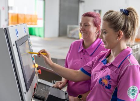 Janelle with co-worker at POS machine