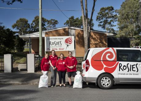 Charity group members collecting empty containers in bags