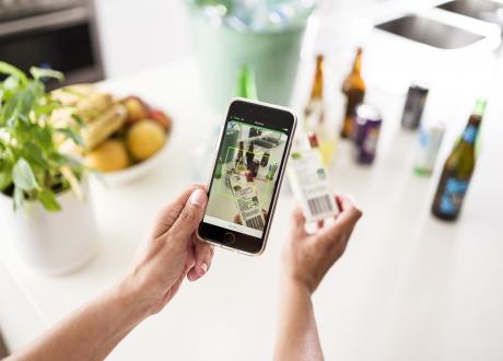 Person holding phone scanning popper barcode