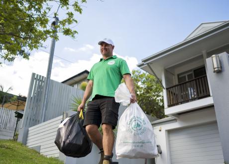 Containers for Change worker collecting containers from customers home