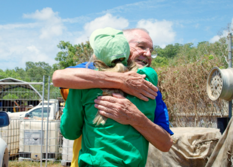 Happy people hugging at recycle depot