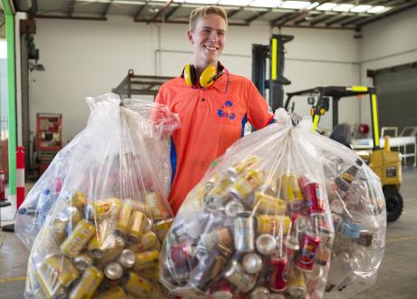 Man holding bags of cans