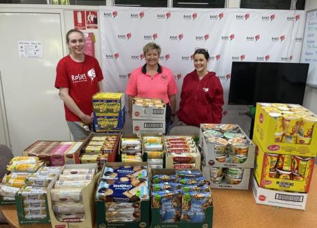 People standing in front of food donations