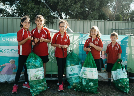 kids standing with collected containers